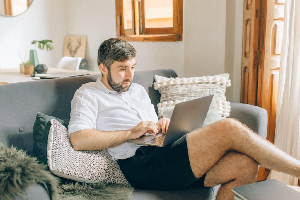 A Man Typing on His Laptop