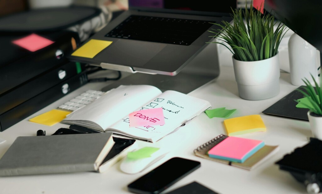 Compliance checklist on an office desk with employee benefits documents, notes, and administrative paperwork highlighting the importance of ACA, ERISA, and COBRA compliance for employers.